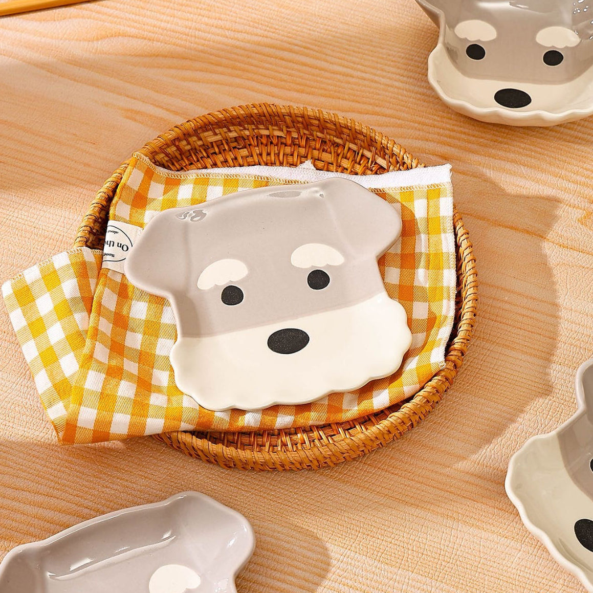 Ceramic dog-shaped plate with a checkered cloth on a wooden surface