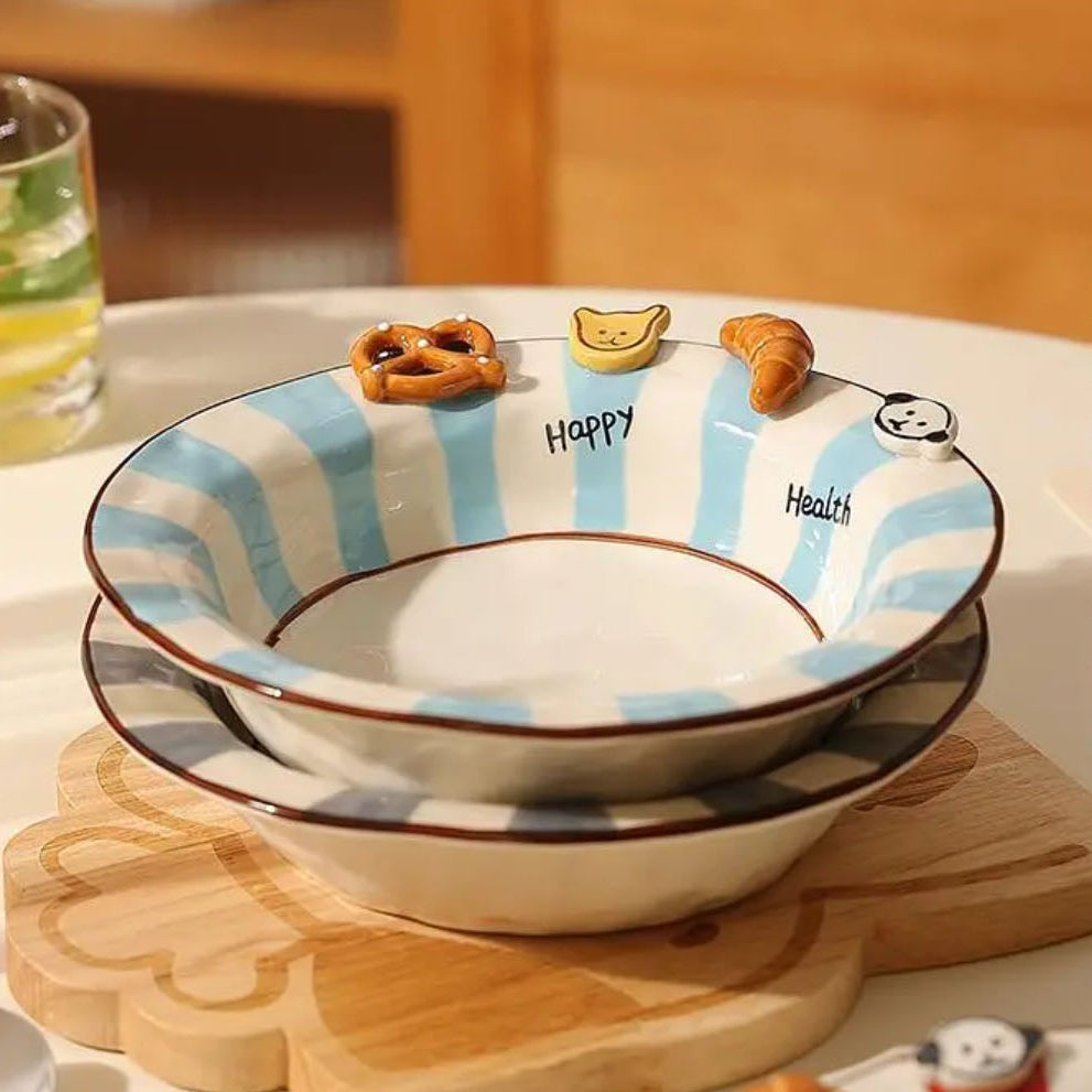 Set of ceramic bowls with striped design on a wooden surface.