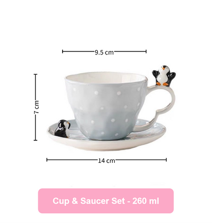 Cup and saucer set with penguin design, including measurements on a white background.