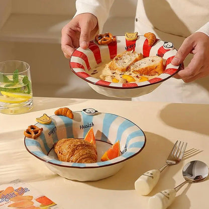 Person holding a striped bowl with food on a table with cutlery and snacks.