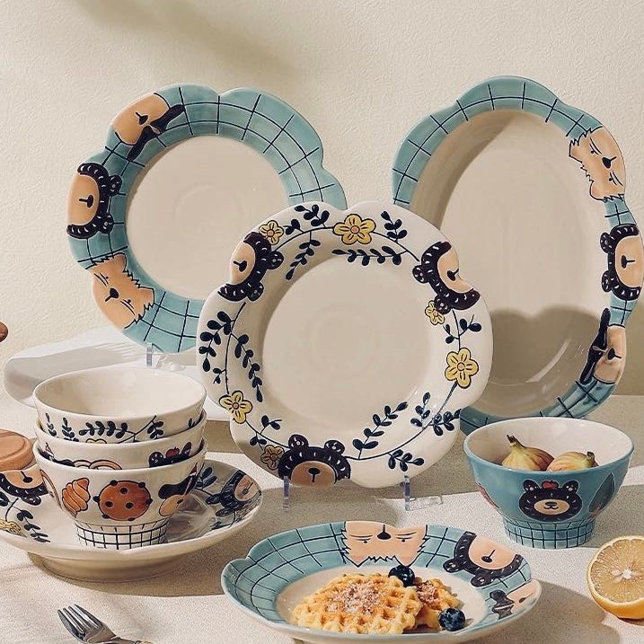 Ceramic tableware set with decorative elements on a neutral background