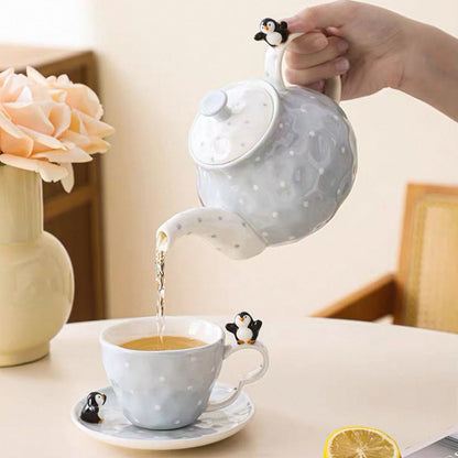 Tea being poured from a ceramic teapot into a cup on a table with a blurred background.