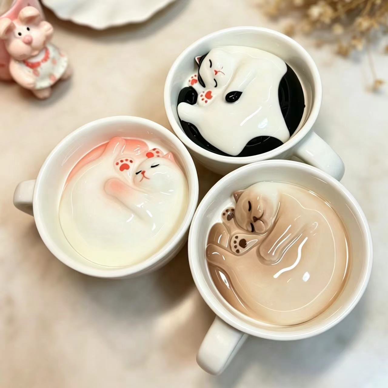 Handmade cat coffee cup and saucer set — lifestyle display, hidden cat inside, MeowCeramics