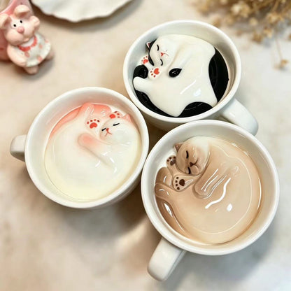 Handmade cat coffee cup and saucer set — lifestyle display, hidden cat inside, MeowCeramics