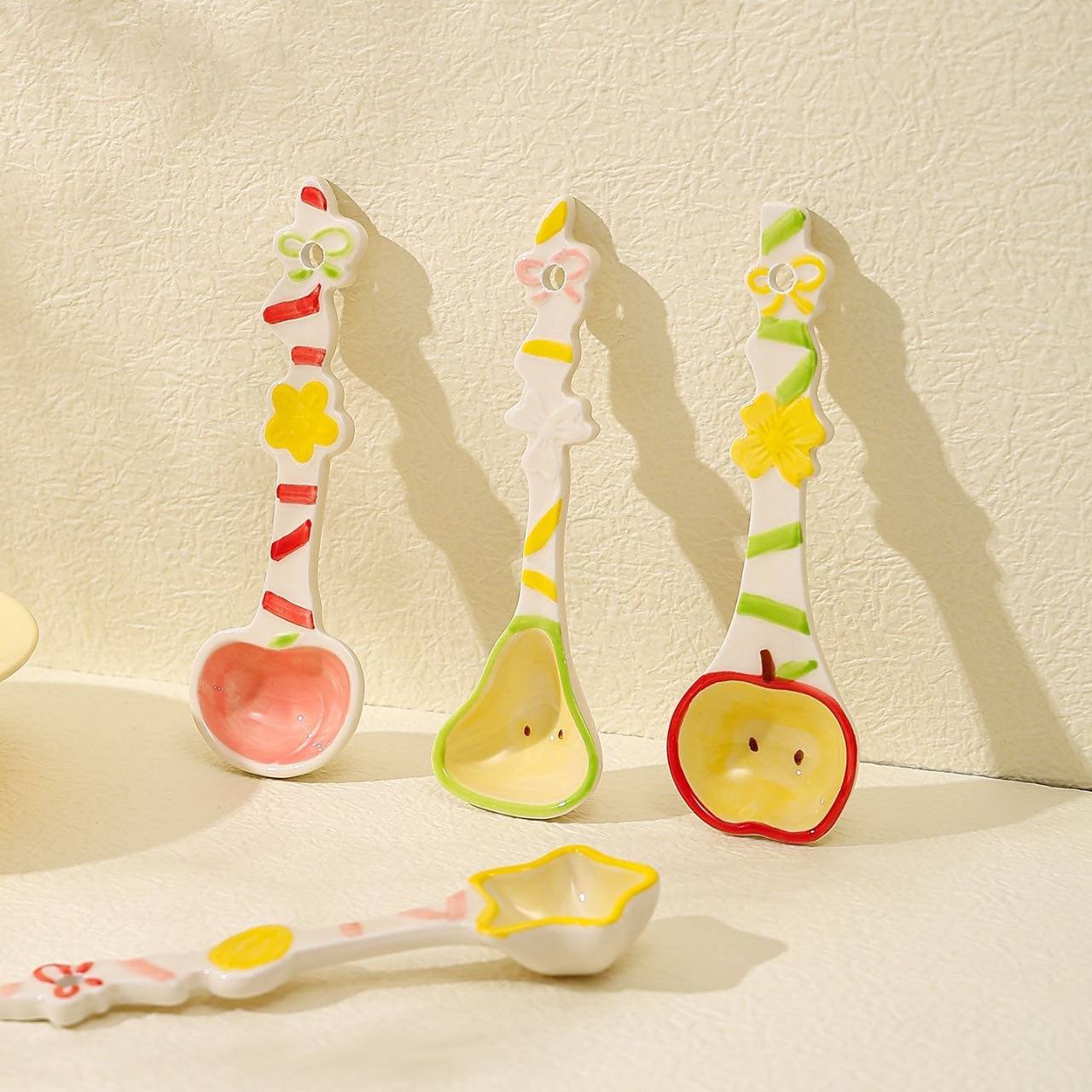 Fruit candy ceramic spoon — lifestyle display, hand-painted candy-stripe handle, MeowCeramics