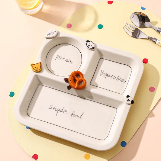 Children's plate with compartments labeled 'Protein', 'Vegetables', and 'Staple food' on a colorful mat.