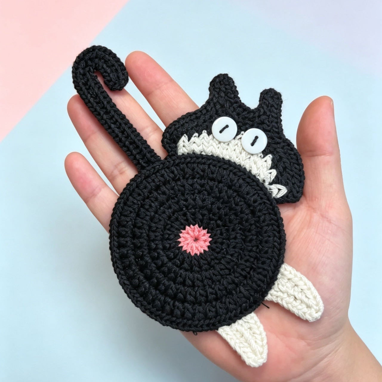 Cat butt crochet coaster size reference — handmade knitted cup mat held in hand, MeowCeramics