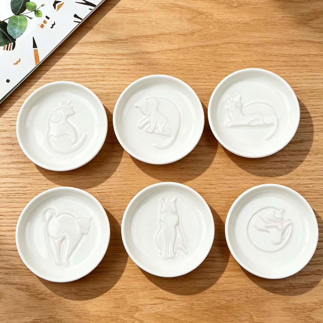 Cat relief sauce dish set — 6 designs, pure white glaze, food-safe ceramic, MeowCeramics
