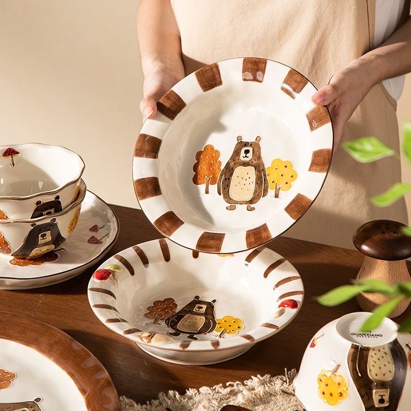 Ceramic plates with bear illustrations on a wooden table