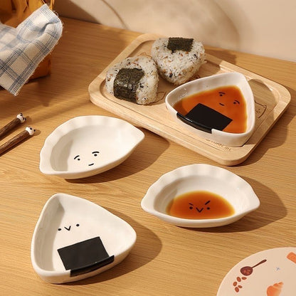Set of cute ceramic bowls shaped like sushi on a wooden table.