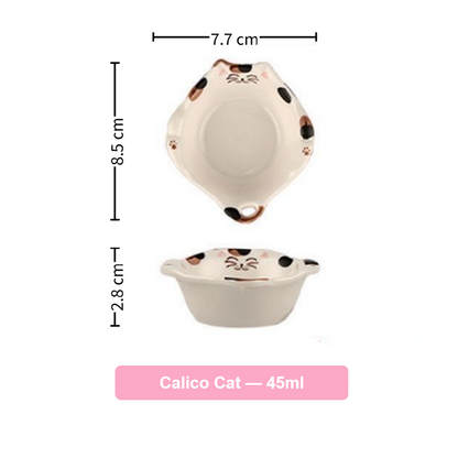 Ceramic cat-shaped bowl with measurements on a white background