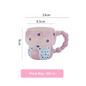 Pink floral mug with measurements on a white background