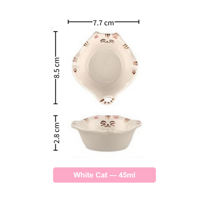 Ceramic bowl with cat design and measurements on a white background