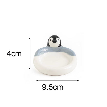 Small penguin figurine with dimensions labeled on a white background