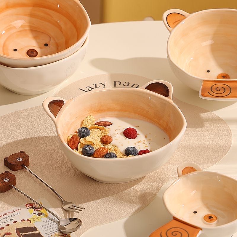 Set of bear-shaped ceramic bowls with cereal and fruit on a matching tray.