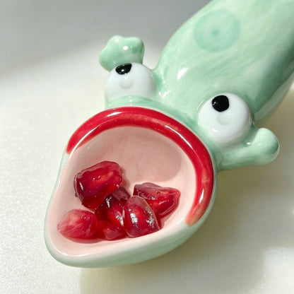 Ugly-cute frog ceramic spoon head detail — hand-painted eyes and mouth, random placement on every piece, MeowCeramics