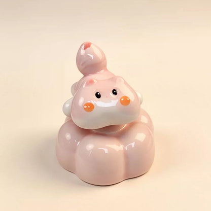 Handmade spinning pink cat ceramic figurine — lifestyle display, rotating desk ornament, MeowCeramics