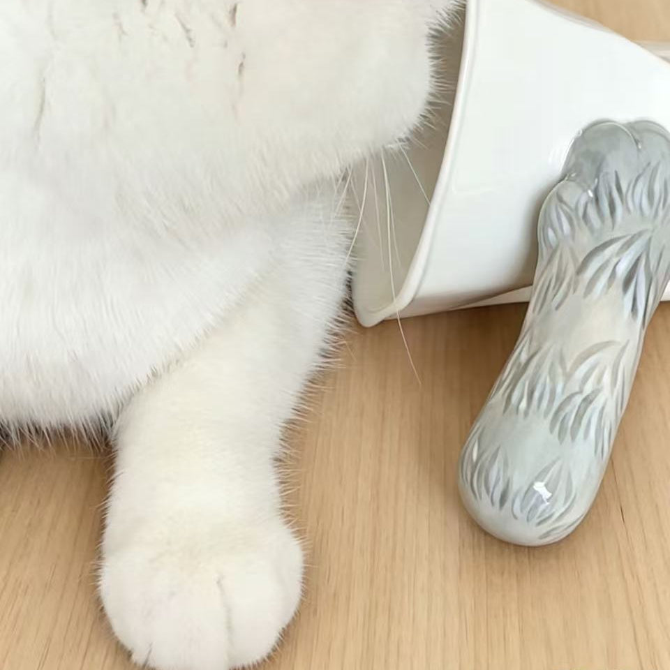 Cat paw tilt mug — silver tabby cat with silver ceramic mug, optical illusion tilt design, MeowCeramics