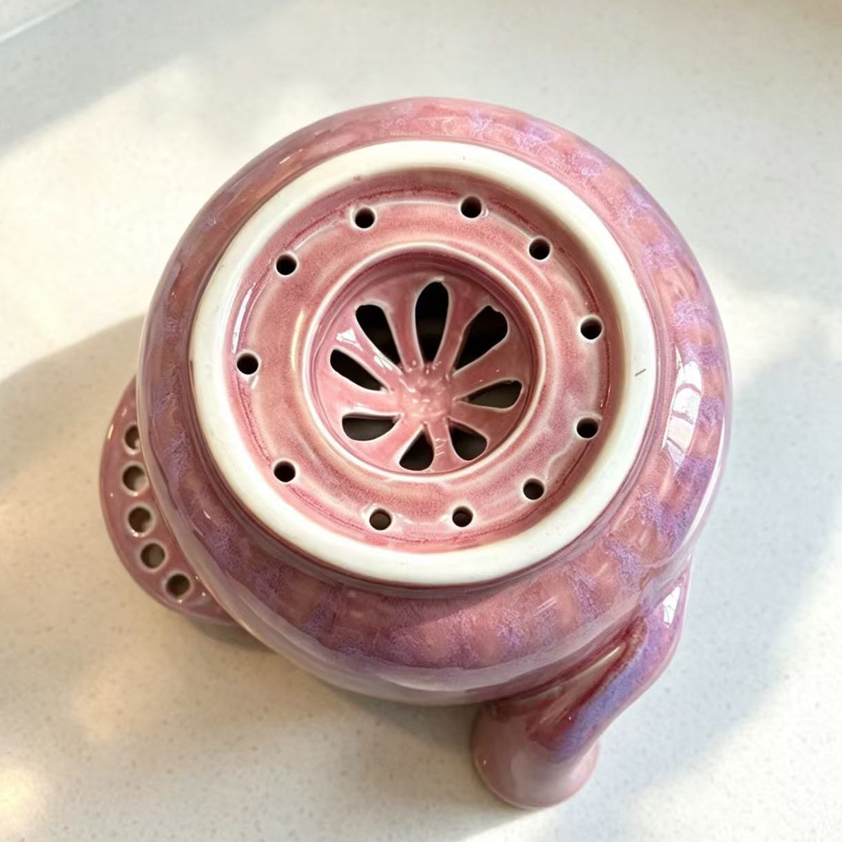 Handmade ceramic swirl berry washing bowl — bottom detail, perforated drainage holes close-up, MeowCeramics