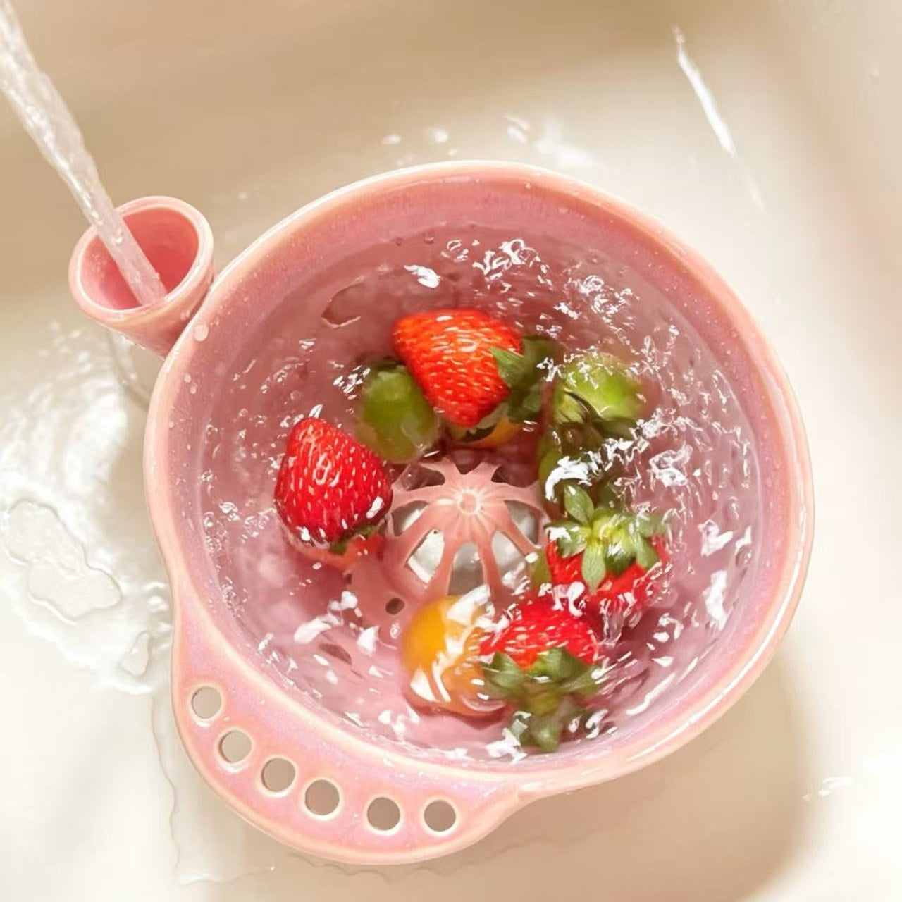 Handmade ceramic swirl berry washing bowl — water vortex in action, gently rinsing fresh berries under running water, MeowCeramics