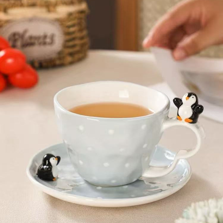 Penguin cup & saucer set — 3D hand-sculpted penguin detail close-up, glacial blue & white ceramic, MeowCeramics
