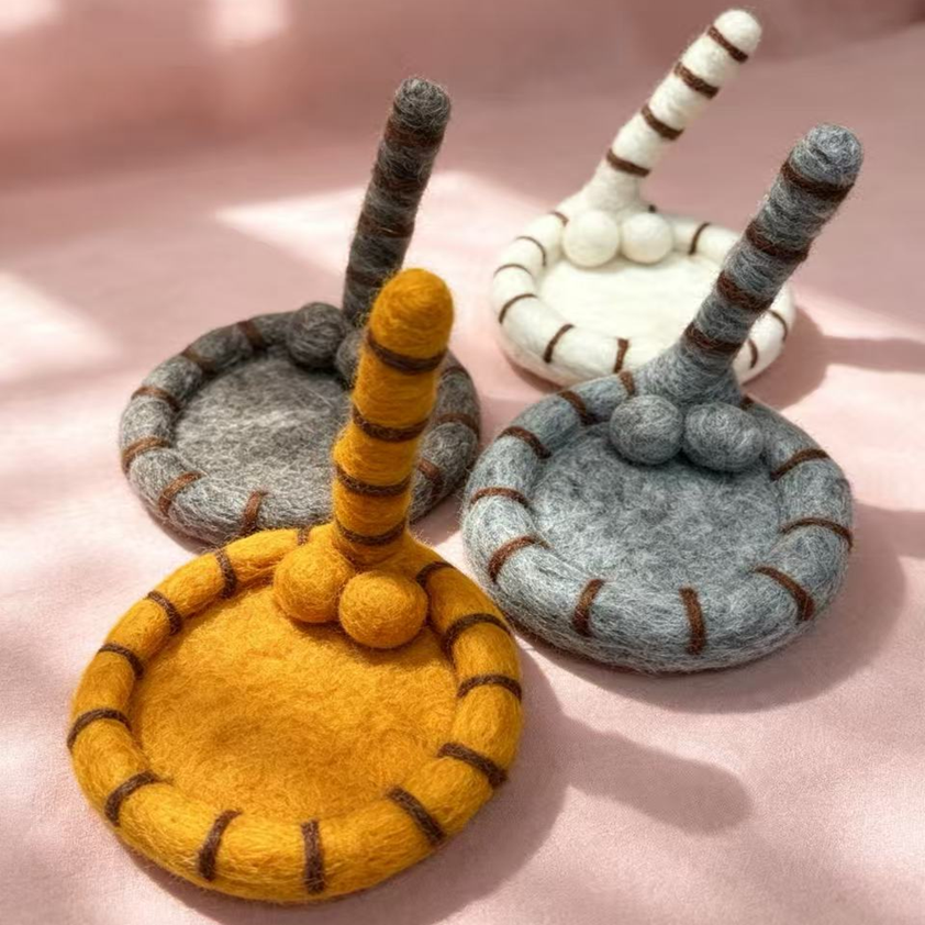 Handmade wool felt cat tail coasters — all 4 colors: orange, cream white, light grey & coffee brown, front view, MeowCeramics