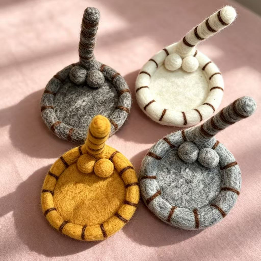 Handmade wool felt cat tail coasters — all 4 colors top view, fluffy cat tail & ball design, MeowCeramics