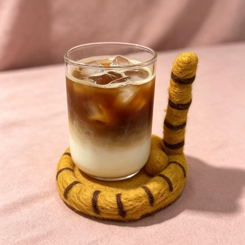 Handmade wool felt cat tail coaster — lifestyle display with coffee cup, heat resistant desk mat, MeowCeramics