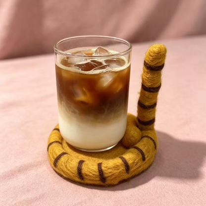 Handmade wool felt cat tail coaster — lifestyle display with coffee cup, heat resistant desk mat, MeowCeramics